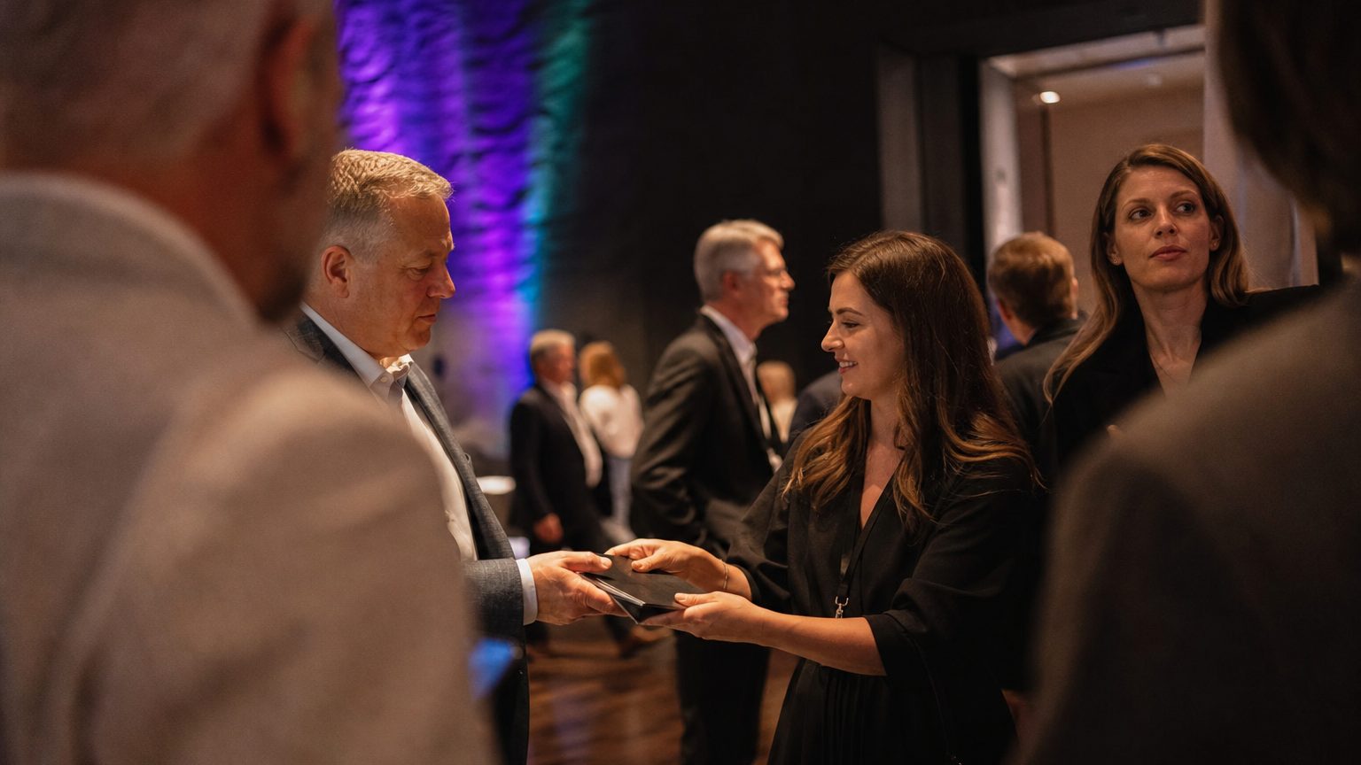 Two brand staff in conversation with attendees at a stand