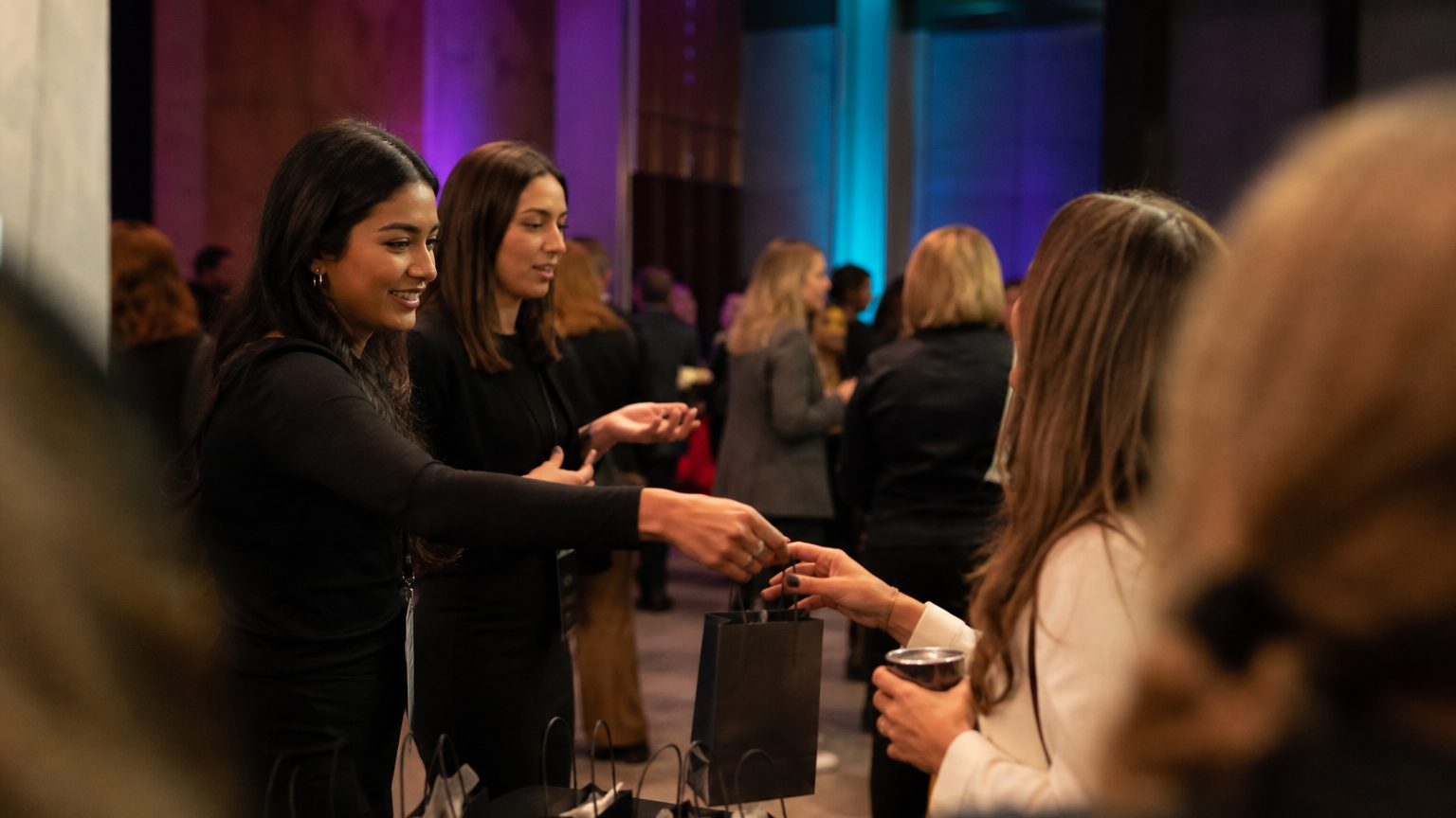Two brand staff in conversation with attendees at a stand