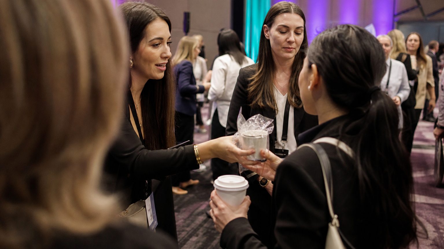 Two brand staff in conversation with attendees at a stand