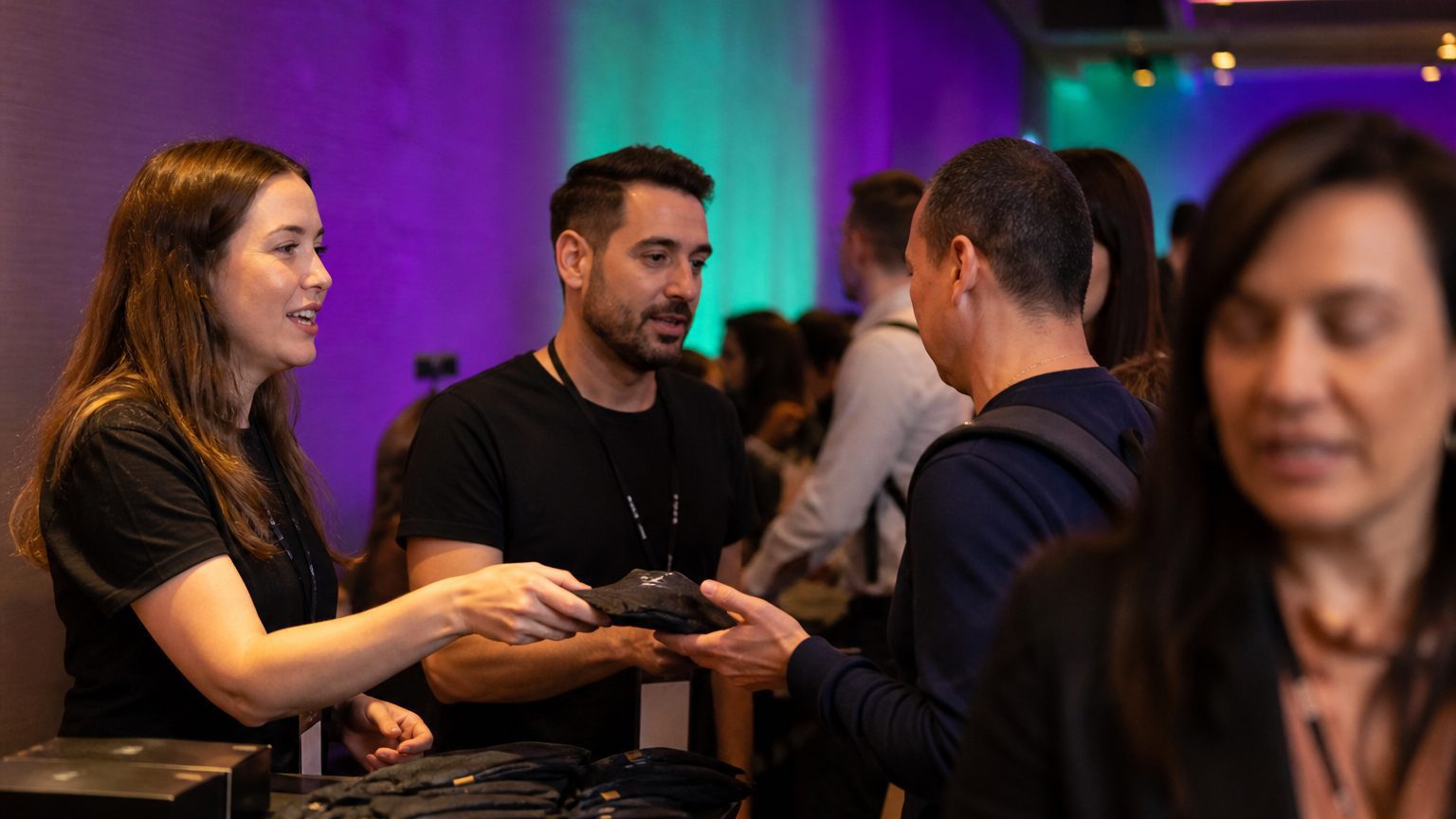 Two brand staff in conversation with attendees at a stand