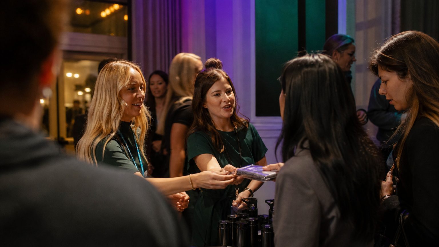 Two brand staff in conversation with attendees at a stand