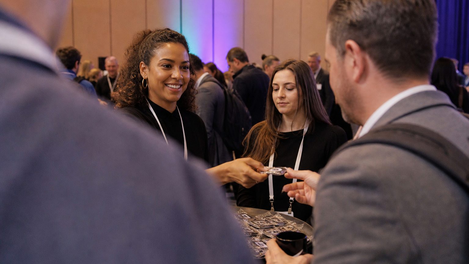 Two brand staff in conversation with attendees at a stand