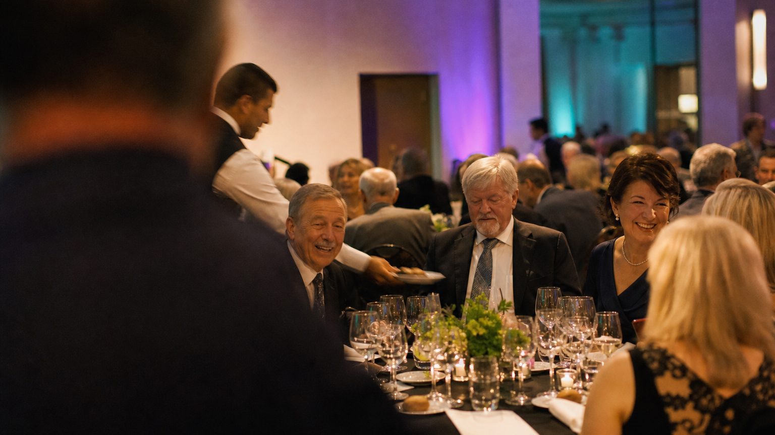 Guests at round tables mid-conversation