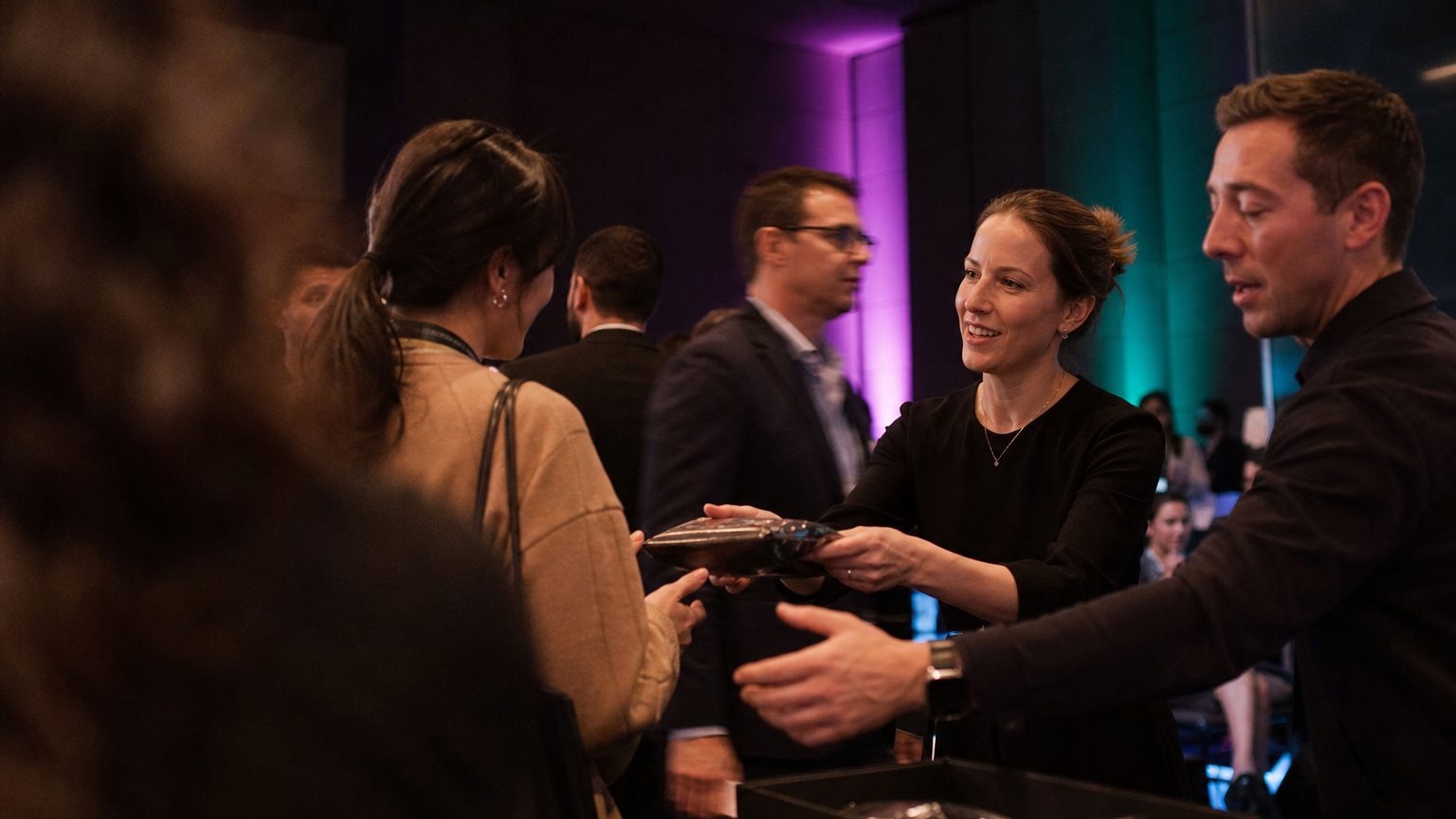 Two brand staff in conversation with attendees at a stand
