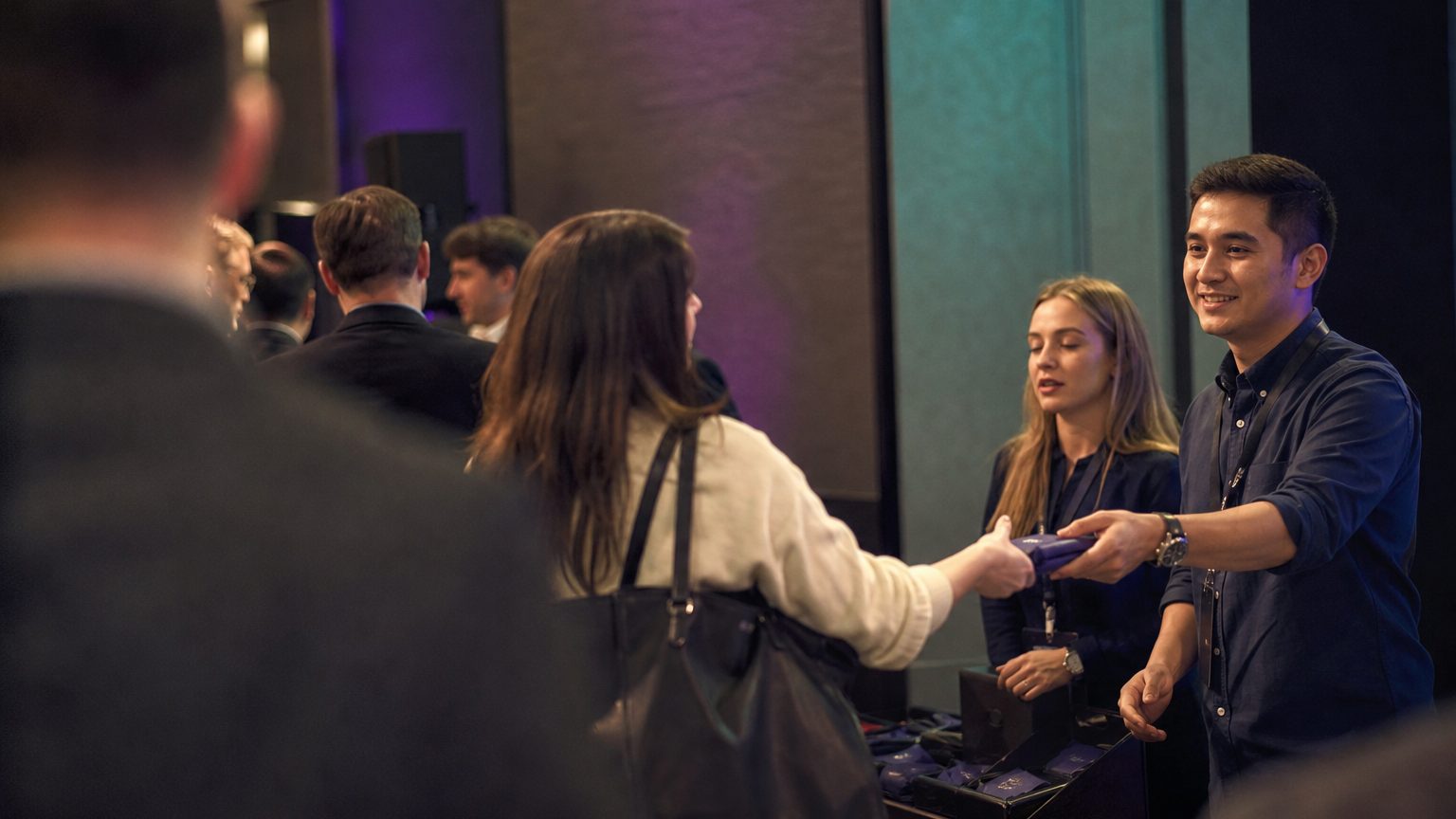 Two brand staff in conversation with attendees at a stand
