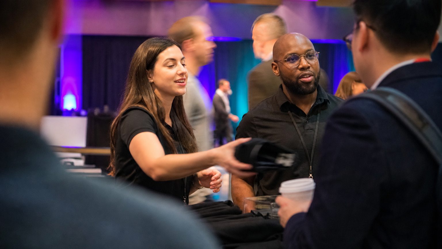 Two brand staff in conversation with attendees at a stand