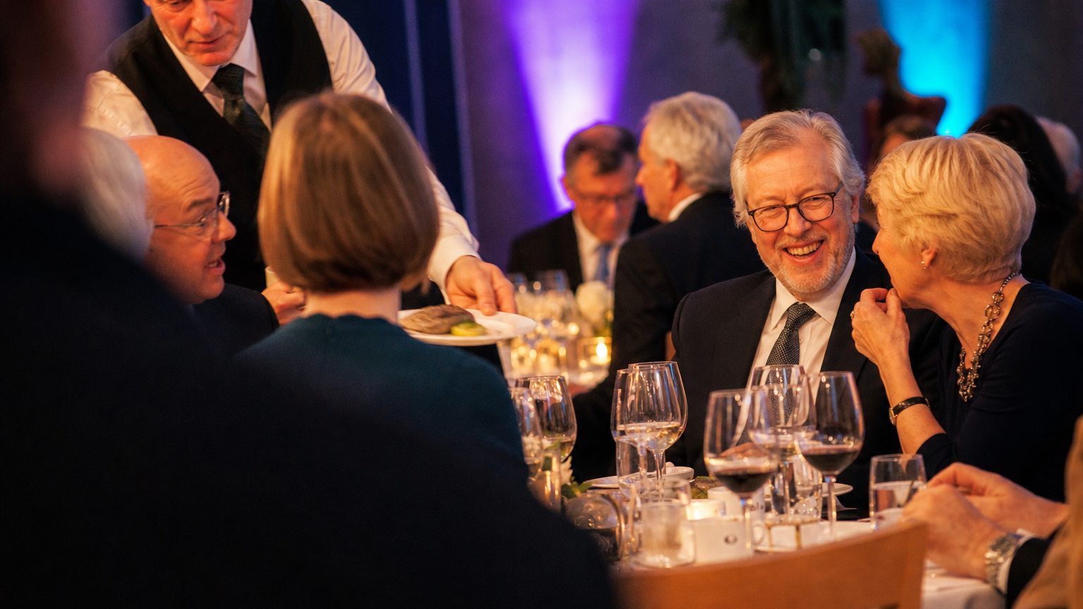 Guests at round tables mid-conversation