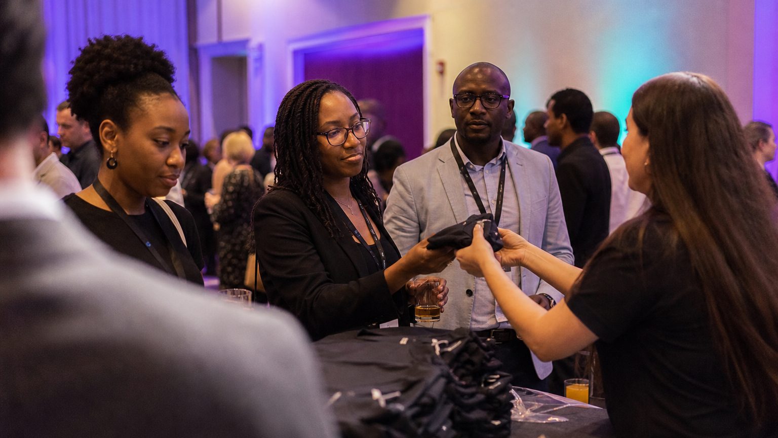 Two brand staff in conversation with attendees at a stand