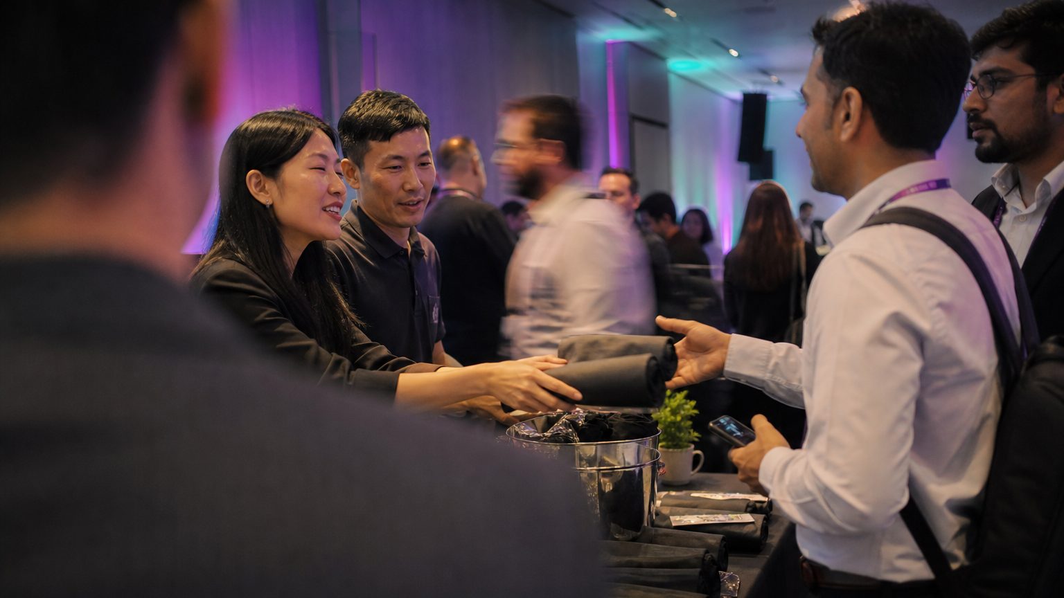 Two brand staff in conversation with attendees at a stand
